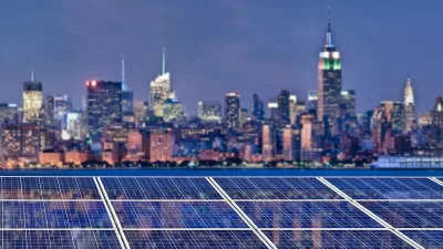 Solar panels with blurred twilight view of New York City skyline witrh Empire State Building in background