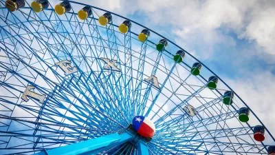 Blue Ferris wheel with Texas state Lone Star logo in middle of wheel.