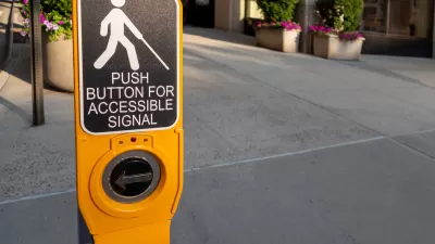 Close-up of yellow pedestrian crossing signal button with text "Push button for accessible signal" and diagram of person holding cane, indicating blindness.