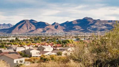 View of large homes in Henderson, Nevada with desert mountains in background.