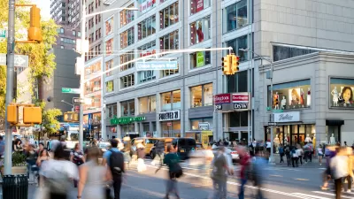 Blurred people walking through busy crosswalk in Manhattan.