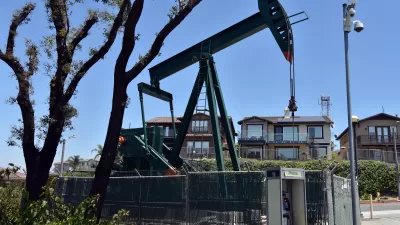 Fenced-in oil pump in residential neighborhood