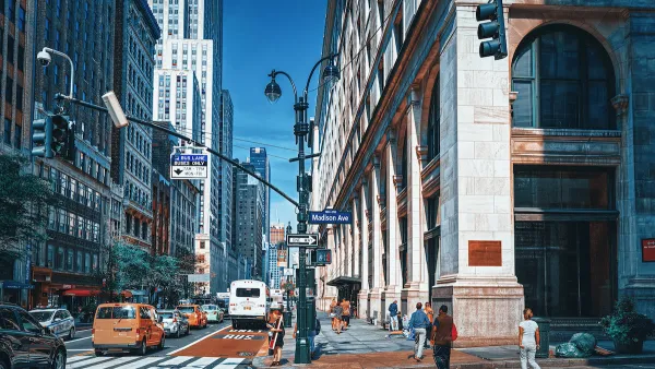 Busy street with red painted bus lane in midtown Manhattan, New York City.