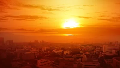 View of city skyline with orange sky indicating extreme heat.