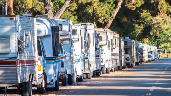 Line of RVs being used as homes parked on street in Mountain View, California.