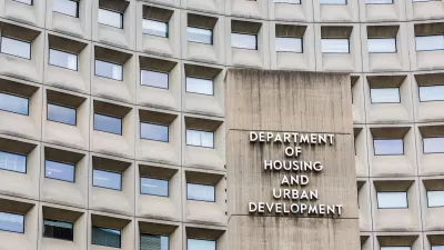 Close-up of office building with windows and sign for Department of Housing and Urban Development in Washington, D.C.