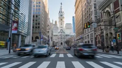 View from middle of crosswalk of Phialdelphia City Hall with blurred traffic.