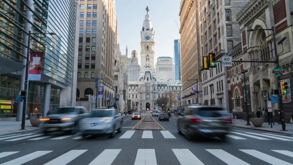 View from middle of crosswalk of Phialdelphia City Hall with blurred traffic.
