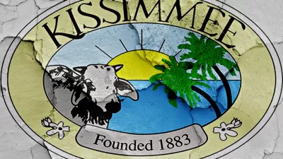 Kissimmee, Florida "Founded 1883" crest painted on cracked wall.