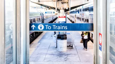 Close-up of 'To Trains' sign above blurred train platform in Washington, D.C.