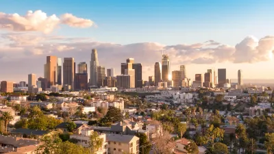 Downtown Los Angeles skyline viewed from the northwest on a sunny day with scattered clouds.