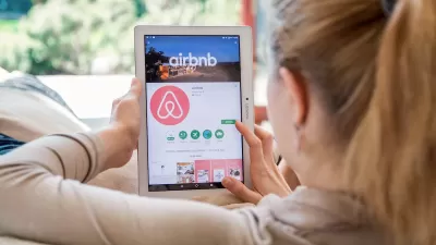 Blonde woman looking for rental on Airbnb app on tablet.