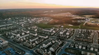Aerial view of white homes and buildings in Clarksburg, Maryland.