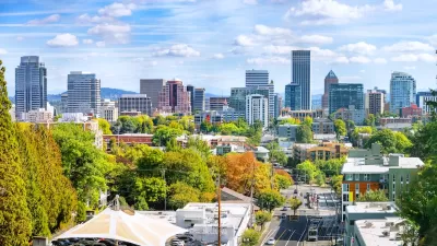View of Portland skyline with green trees in foreground.