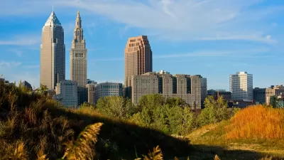 CLeveland, Ohio downtown skyline seen from grassy field.