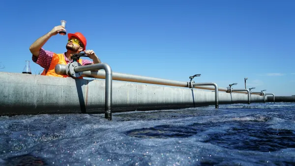 An engineer controlling a quality of water ,aerated activated sludge tank at a waste water treatment plant. 