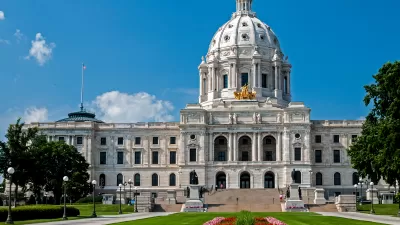 Minnesota state capitol building with red flowers on green front lawn
