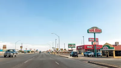 Six-lane road with fast food and pizza restaurants in Alamogordo, New Mexico.