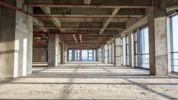 Interior of vacant/unfinished concrete open plan office building.