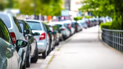 Row of parked cars along curb.