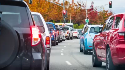 View of cars stuck in gridlocked traffic with traffic lights in background