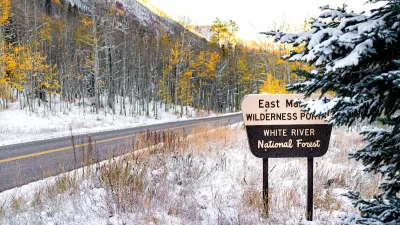 Maroon Bells sign for wilderness portal and white river national forest in Aspen, Colorado rocky mountain covered in snow after winter frozen in autumn 2019.