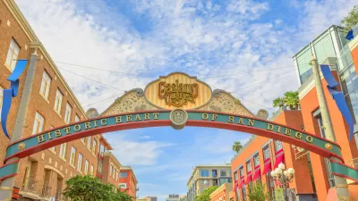 Arched entrance sign over street to San Diego's historic Gaslamp Quarter with slogan "historic heart of San Diego."