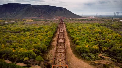 Aerial view of Gillespie Bridge with metal framing and black rock mesa in background in Gillespie, Arizona.