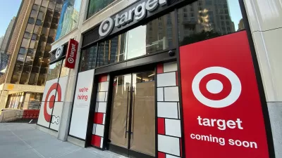 Storefront of small Target in New York City with "coming soon" and "now hiring" signs in window.