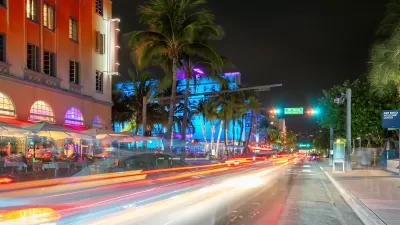 View of blurred traffic on South Beach, Miami street at nighttime.
