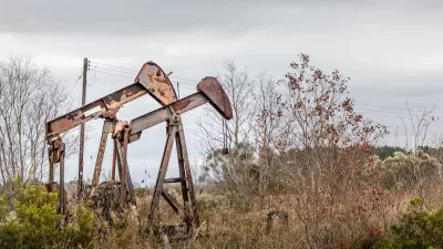 Two rusty, abandoned oil pumps in rural Texas.