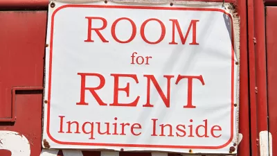 Red on white 'Room for Rent, Inquire Inside' sign
