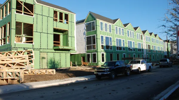 Three-story wood-frame apartment buildings under construction 