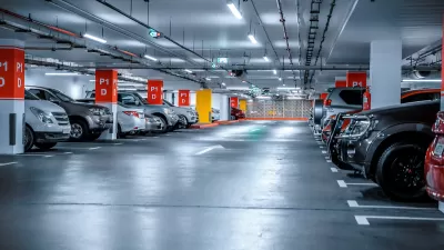 Underground parking garage full of parked cars.