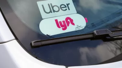 Clpse=up of Uber and Lyft stickers inside a car windshield.