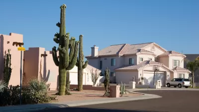 Suburban Phoenix single-family homes in a cul-de-sac, one with large saguaro cactus in front yard