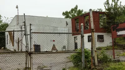 Abandoned, decaying building behind locked chain link fence in Atlanta, Georgia