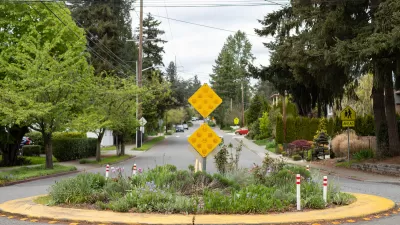 Roundabout with landscaping in middle in residential street.