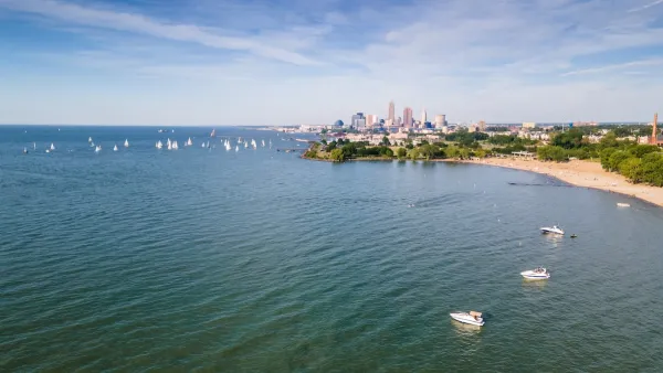 Lake Erie waterfront with many small boats and Cleveland, Ohio buildings in background.