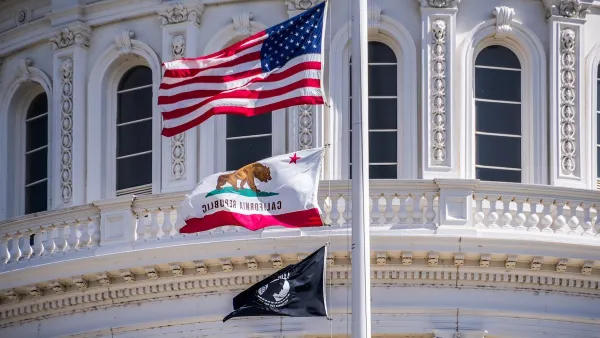 Close-up of U.S., California, and POW-MIA flags on California state capitol dome.