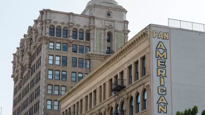 Historic buildings in downtown Los Angeles with large "Pan American Lofts" sign on side of building.