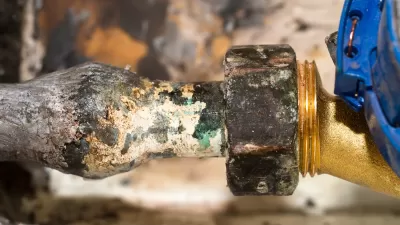 Close-up of lead water pipe with mineral crusts