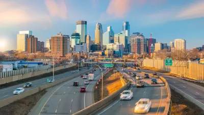 View of Minneapolis freeway with downtown skyline in background with light traffic at golden hour.