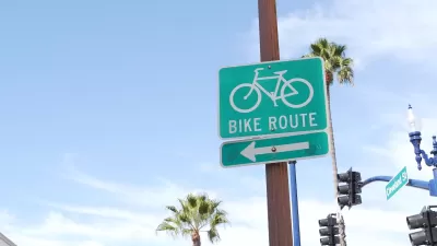 Close-up of green and white Bike Route sign with arrow in California.
