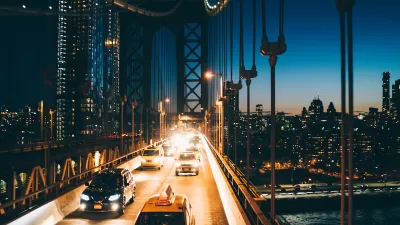 View of traffic on bridge going into Manhattan, New York City at night.