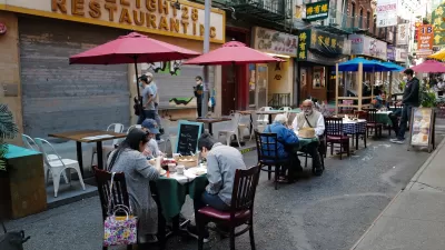 Patrons at restaurant in New York City eating at ourdoor tables in closed-off alleyway during Covid-19 pandemic in 2020.