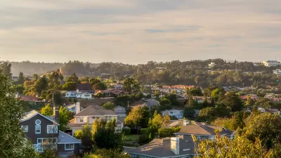 Aerial view of houses against partly cloudy sky in San Mateon County, California.