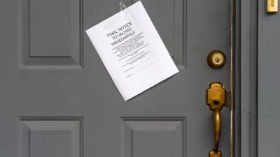 Eviction notice on white paper taped to grey door