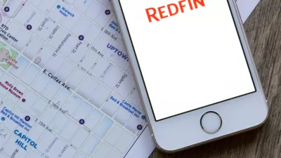 IPhone with Redfin app open, sitting on top of tablet with Google Maps of Portland on the screen.