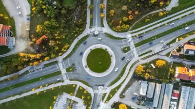 Bird's eye view of roundabout with two lanes and four branches.